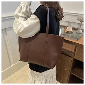 Deep brown tote bag with pebble texture faux leather and elegant vertical stitching