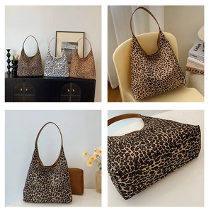 Detail view of large leopard print tote bags in brown and beige tones with leather straps