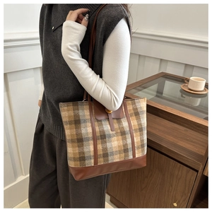 Detail of vintage brown plaid wool tote bag with premium leather trim and large capacity