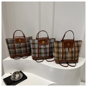 Detail of plaid tweed backpacks with leather trim and gold metal buckles in various colors