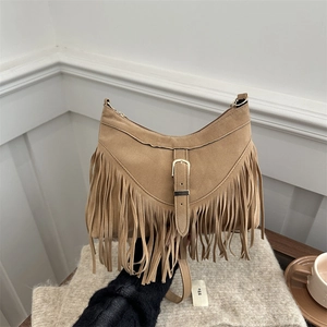 Bohemian suede tassel shoulder bag in camel with metallic buckle and slim strap