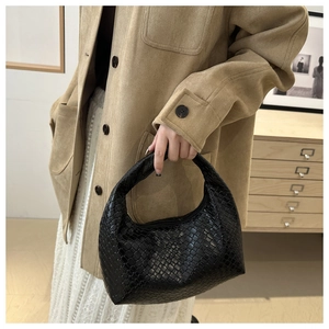 Detail of the high-quality black woven texture on this stylish hobo handbag for women