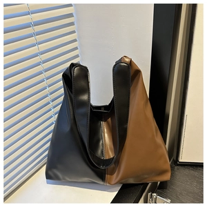 Detail view showing black and brown contrast stitching on matte PU leather tote bag