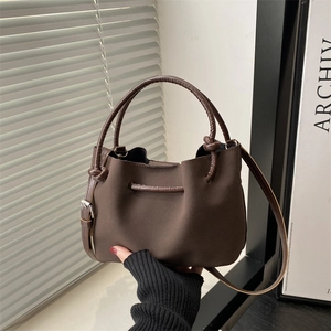 Vintage dark brown suede bucket handbag with dual handles and adjustable strap for women