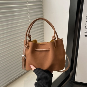 Brown faux suede handbag with knot handle and adjustable strap for winter fashion