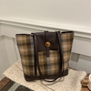Vintage checkered tote bag with brown leather trim and golden N detail on white fabric