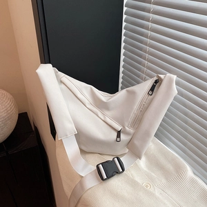 Minimalist white nylon crossbody sling bag with adjustable strap and dual front pockets