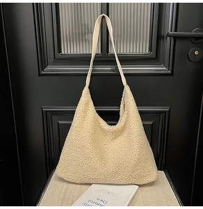 Detail of soft cream plush fleece texture on a large minimalist shoulder tote bag