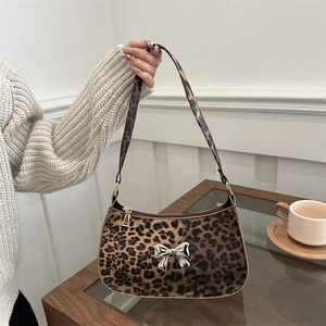 Leopard print baguette bag with a silver metal bow and matching shoulder strap