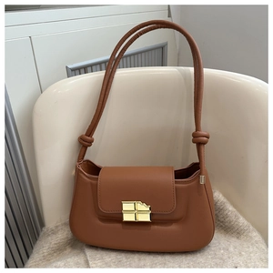 Detail of caramel brown PU leather bag featuring unique chocolate-shaped gold lock