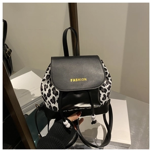 Close-up of leopard print mini backpack featuring a gold FASHION logo and drawstring detail