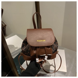 Detail of leopard print and brown leather mini backpack with FASHION lettering