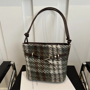 Classic green plaid winter bucket bag with leather strap and gold metal buckle hardware
