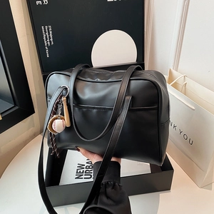 Large black matte leather Boston tote bag with baseball charms and versatile straps