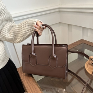 Elegant dark brown structured handbag with dual handles and adjustable shoulder strap