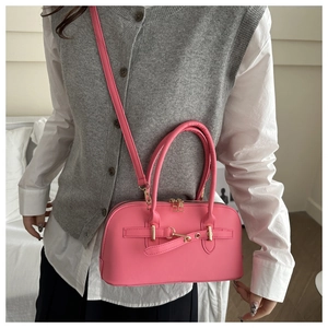 Close-up of Barbie pink Boston bag with gold zipper and adjustable shoulder strap