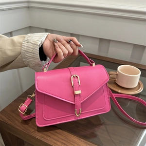 Fashionable magenta envelope crossbody bag with gold buckle and top handle for women