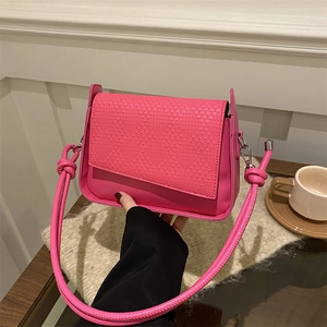 Fashionable bright pink woven texture handbag with crossbody strap and knot detail