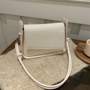 Minimalist cream white woven crossbody bag with knotted shoulder strap detail