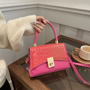 Chic pink and orange faux crocodile crossbody bag with golden metal ring handle