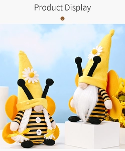 Detail of bee gnomes with striped hats, white braids, and wings on a display stand