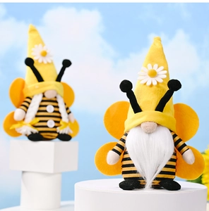 Detail of bee gnomes with yellow wings, felt stripes, and daisy pattern on tall hats