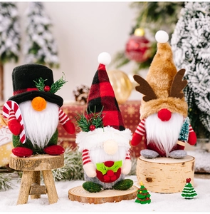 Close-up of Christmas gnomes with plaid hats, reindeer antlers and mini holiday accessories