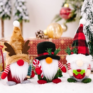 Three Christmas gnomes set with plaid hats and reindeer antlers on a snowy background