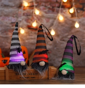 Close-up of glowing Halloween gnomes with LED lights, knit hats, and spider bat decals