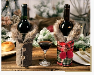 Detail of Christmas wine bottle covers in plaid and herringbone styles with faux fur collars