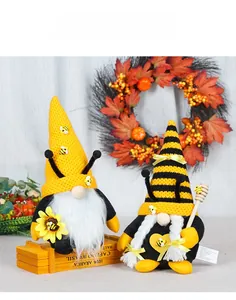 Close-up of handmade bee gnomes featuring sunflowers and plush knitted textures