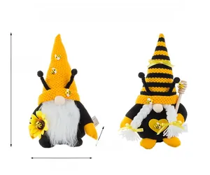 Detail view of sunflower bee gnomes with yellow knit hat and honey stirrer stick