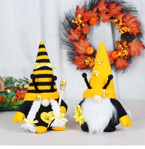 Detail of bee festival gnome ornaments with knitting hats and sunflower props