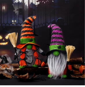 Detail of Halloween gnome set with spider hats, orange braids, and straw brooms decoration