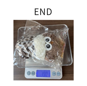 Detailed view of plush owl doll weighing 190.1g on a digital scale for shipping