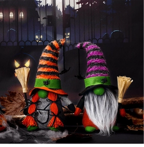 Close-up of Halloween gnome plush dolls with striped hats and mini straw brooms