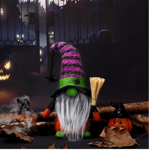 Detail shot of Halloween gnome with striped hat and broom in a spooky scene