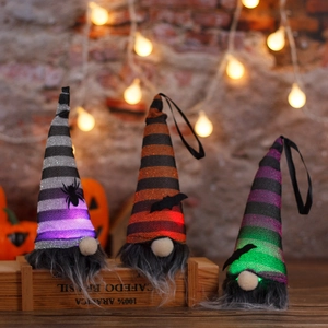 Three glowing Halloween gnomes with LED lights, striped sequin hats on a rustic shelf