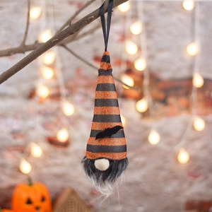 Halloween gnome plush ornament with bat wings and glowing light hanging on branch