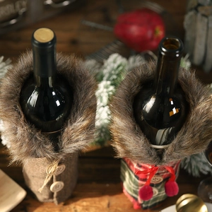 Christmas wine bottle covers in red plaid and tweed with faux fur collars on wooden table