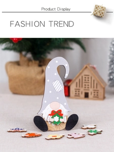 Detail view of wooden gnome ornament with interchangeable seasonal accessories on table