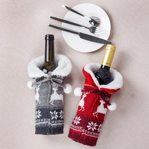 Knitted Christmas wine bottle covers with reindeer and snowflake patterns in red and grey