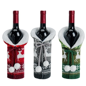 Three Christmas knitted wine bottle covers with reindeer patterns and plush collars