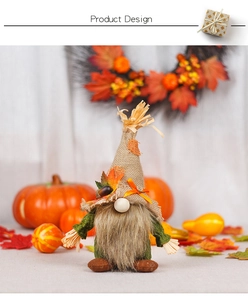 Close-up of autumn gnome decor with burlap hat, maple leaf and sunflower details