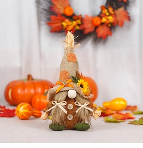 Close-up of autumn gnome doll with burlap hat sunflower and wood buttons detail