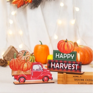 Detail of wooden pumpkin truck and Happy Harvest sign with warm festive lighting