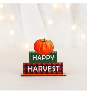 Macro shot of Harvest Day wooden pumpkin decor with Happy Harvest text on light fabric