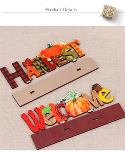 Detail view of wooden harvest table signs with pumpkin designs and harvest text