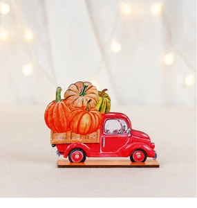 Detail of red vintage truck wooden decor with pumpkins for harvest and Thanksgiving settings