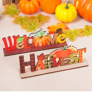 Detail of wooden Harvest and Welcome tabletop signs with pumpkin and maple leaf designs